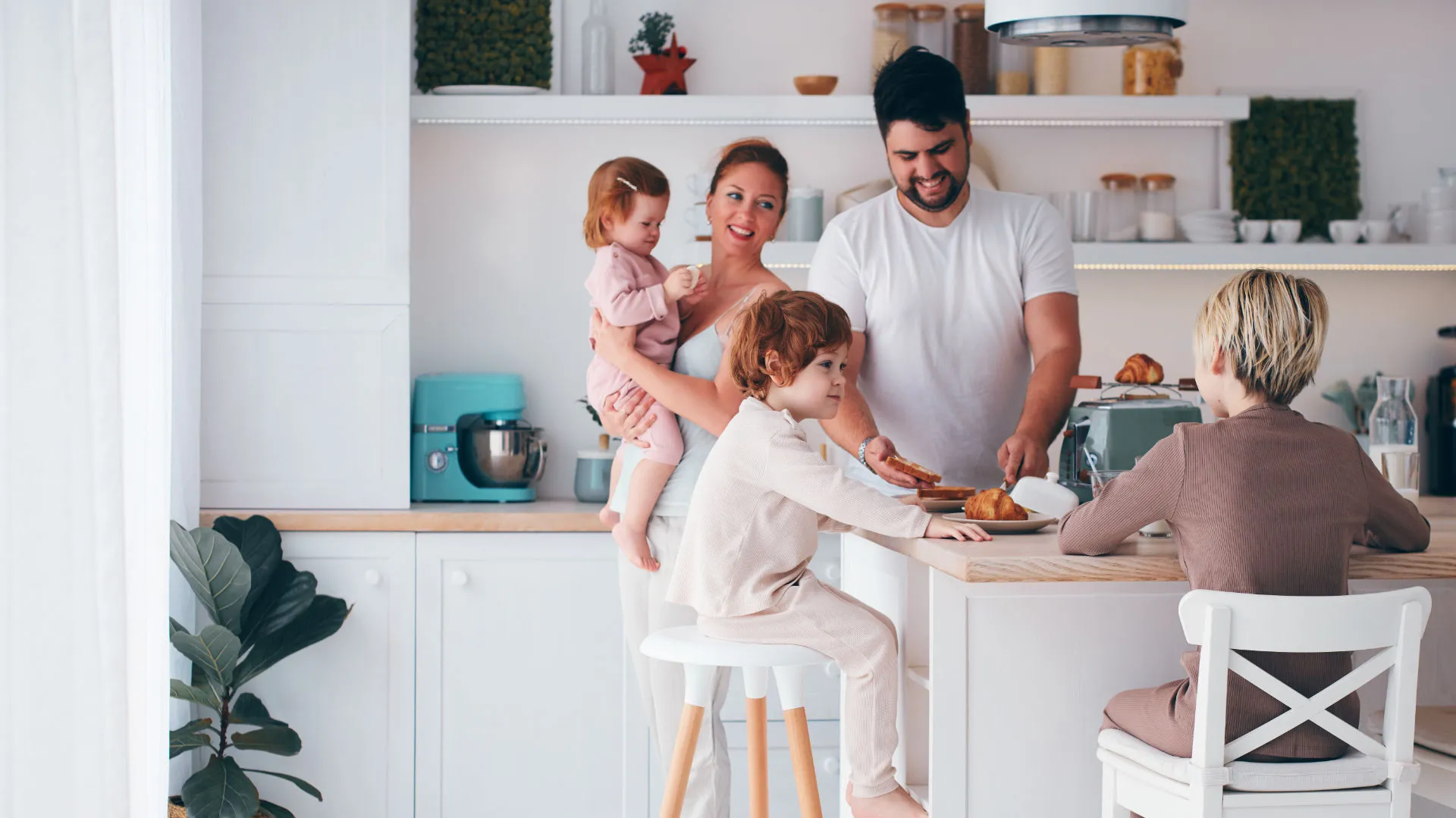 A young family enjoying breakfast in a modern kitchen